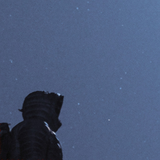 A hooded guy looking into the night sky